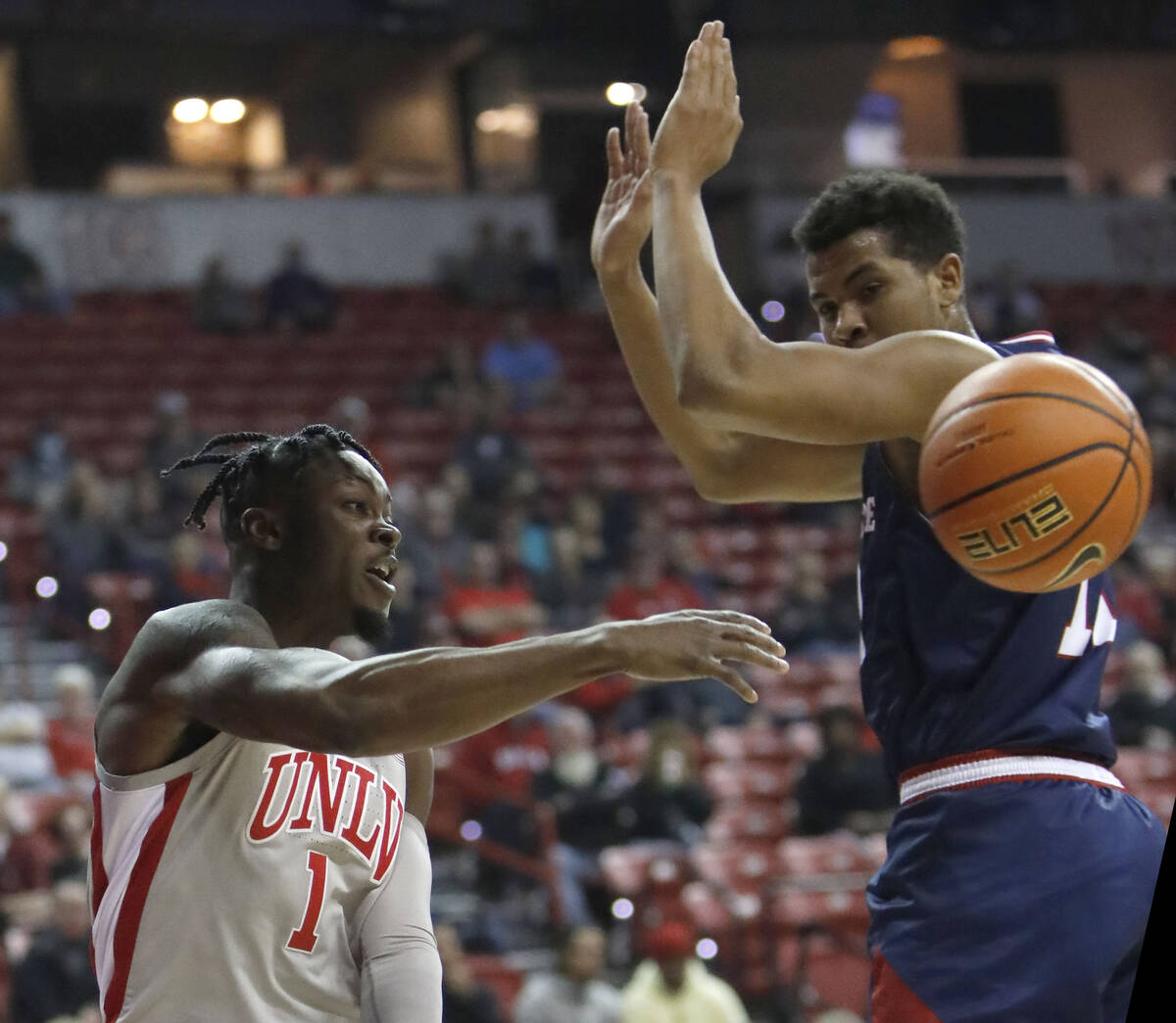 UNLV Rebels guard Michael Nuga (1) passes a ball as Fresno State Bulldogs forward Orlando Robin ...