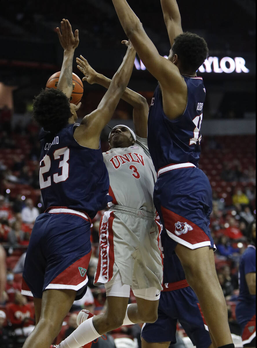 UNLV Rebels forward Donovan Williams (3) goes to the basket as Fresno State Bulldogs guard Leo ...