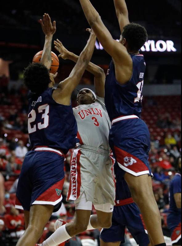 UNLV Rebels forward Donovan Williams (3) goes to the basket as Fresno State Bulldogs guard Leo ...