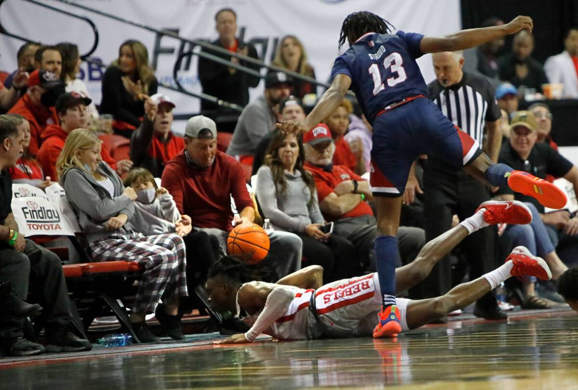 UNLV Rebels forward Victor Iwuakor (0) and Fresno State Bulldogs guard Deon Stroud (13) battle ...