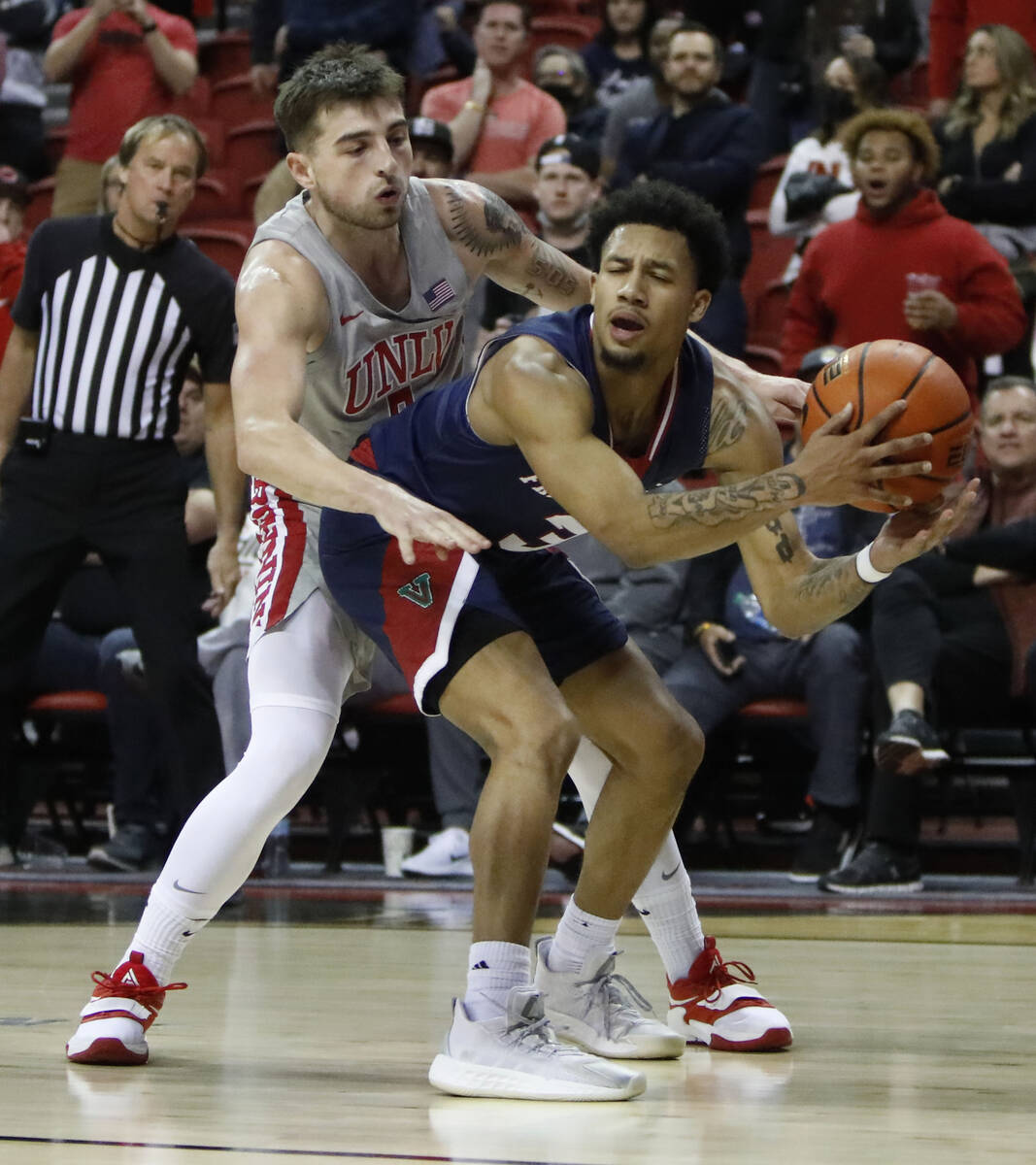 Fresno State Bulldogs guard Isaiah Hill (3) keeps a ball away from UNLV Rebels guard Jordan McC ...