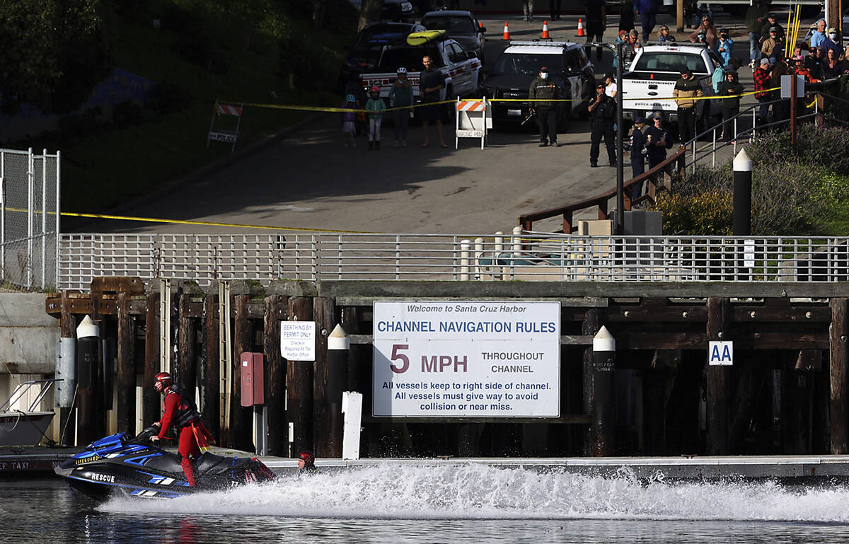 Lifeguards speed out of the Santa Cruz Small Craft Harbor, Saturday, Jan. 15, 2022, in the morn ...