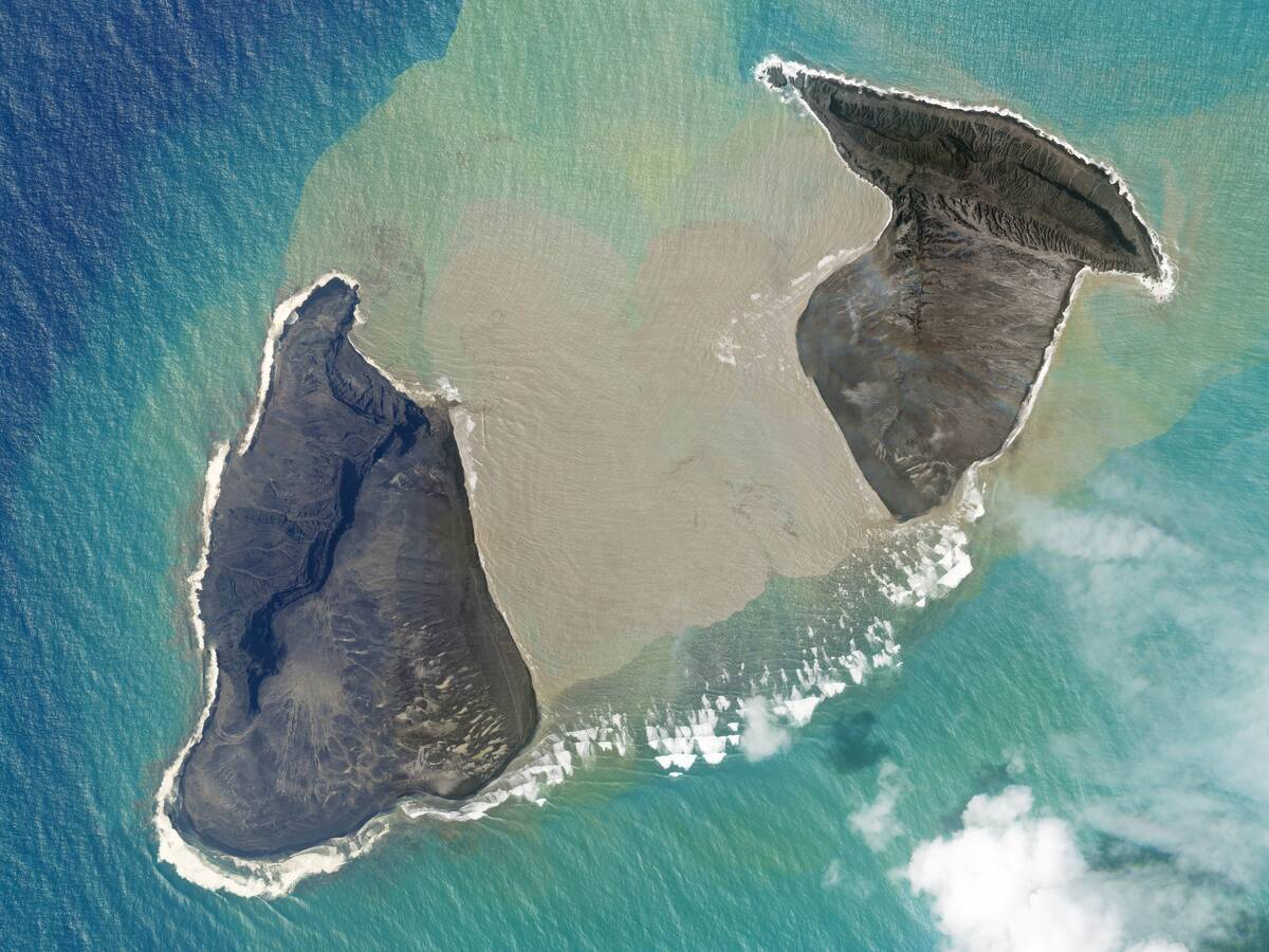 In this satellite photo taken by Planet Labs PBC, an island created by the underwater Hunga Ton ...