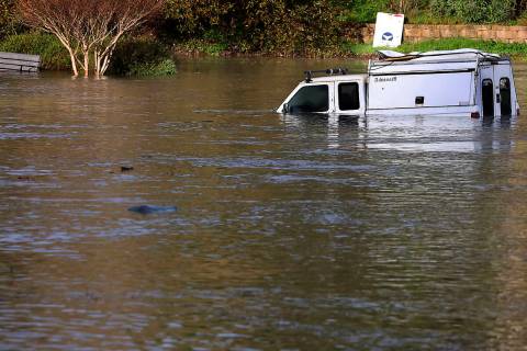A pickup truck is partially submerged in Santa Cruz, Calif., early Saturday, Jan. 15, 2022, as ...