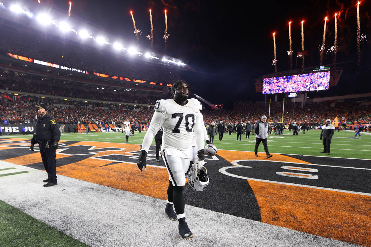 Raiders guard Alex Leatherwood (70) walks off the field after his team’s loss against th ...