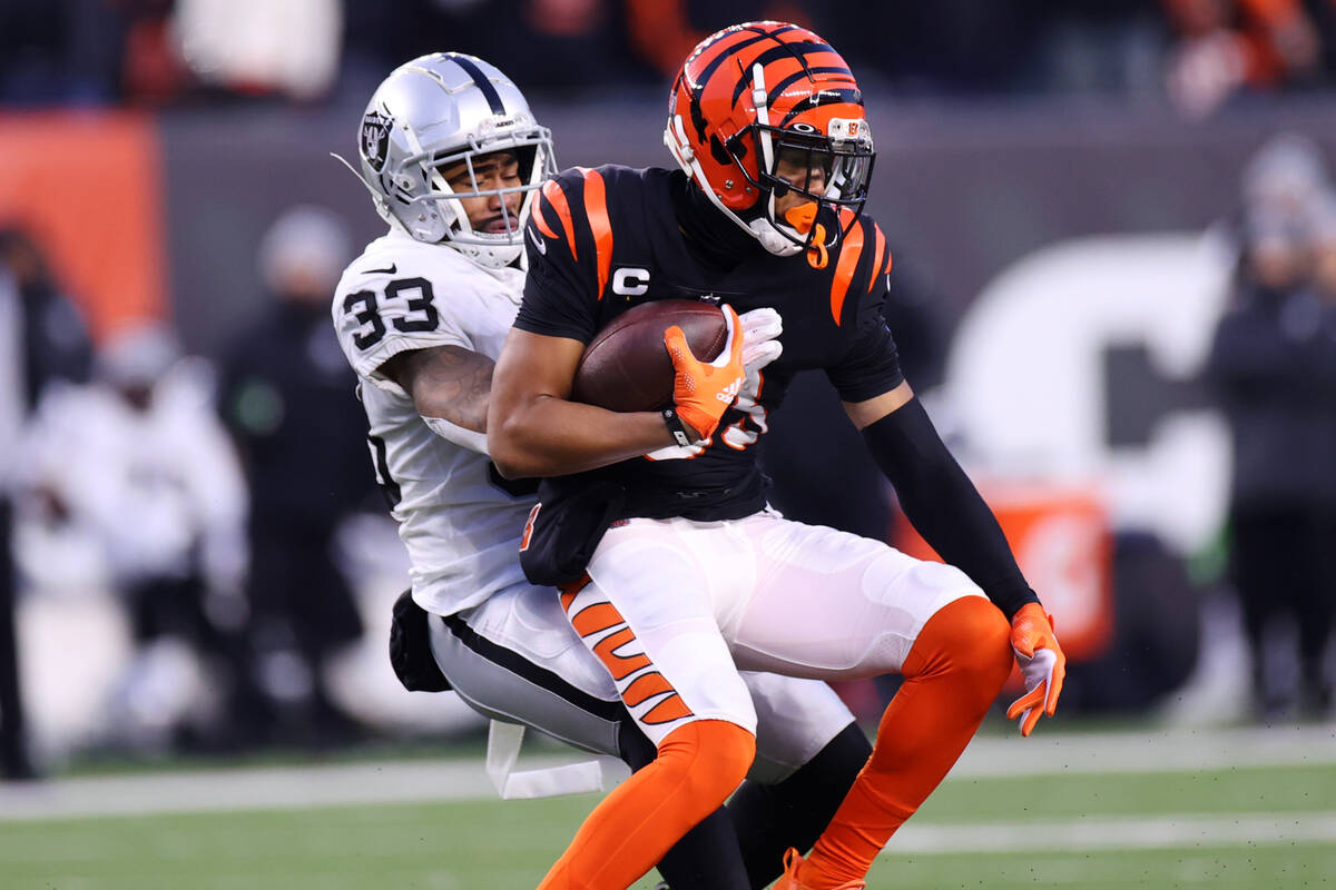 Raiders safety Roderic Teamer (33) tackled Cincinnati Bengals wide receiver Tyler Boyd (83) in ...