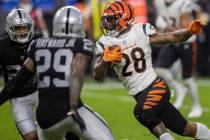 Cincinnati Bengals running back Joe Mixon (28) rushes past Raiders cornerback Casey Hayward (29 ...