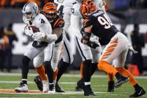 Raiders quarterback Derek Carr (4) is sacked by Cincinnati Bengals defensive end B.J. Hill (92) ...