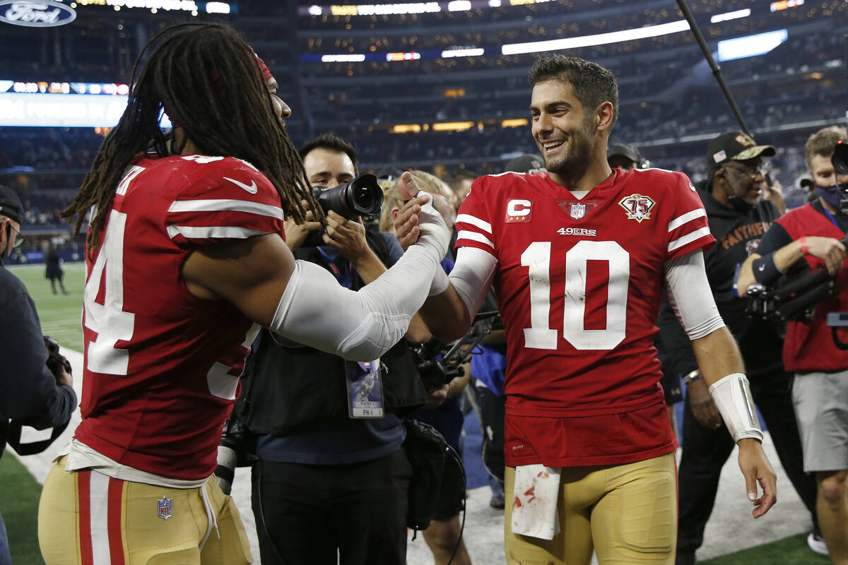 San Francisco 49ers middle linebacker Fred Warner, left, celebrates with quarterback Jimmy Garo ...