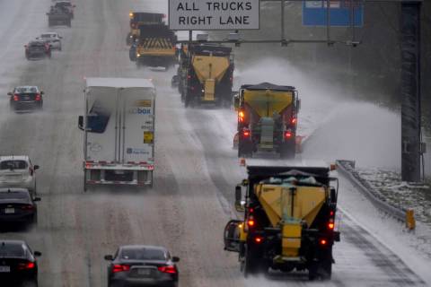 Vehicles navigate hazardous driving conditions along Interstate 85/40 as a winter storm moves t ...