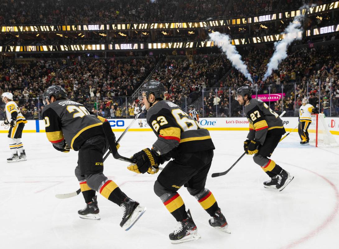 Golden Knights center Chandler Stephenson (20) celebrates with teammate after scoring a fist pe ...