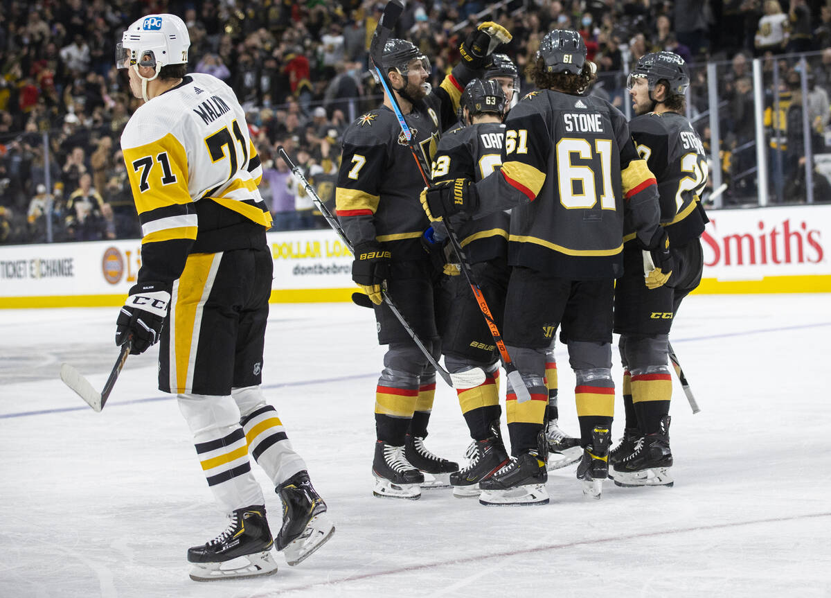 Golden Knights celebrate a first period goal by right wing Evgenii Dadonov (63) during an NHL h ...