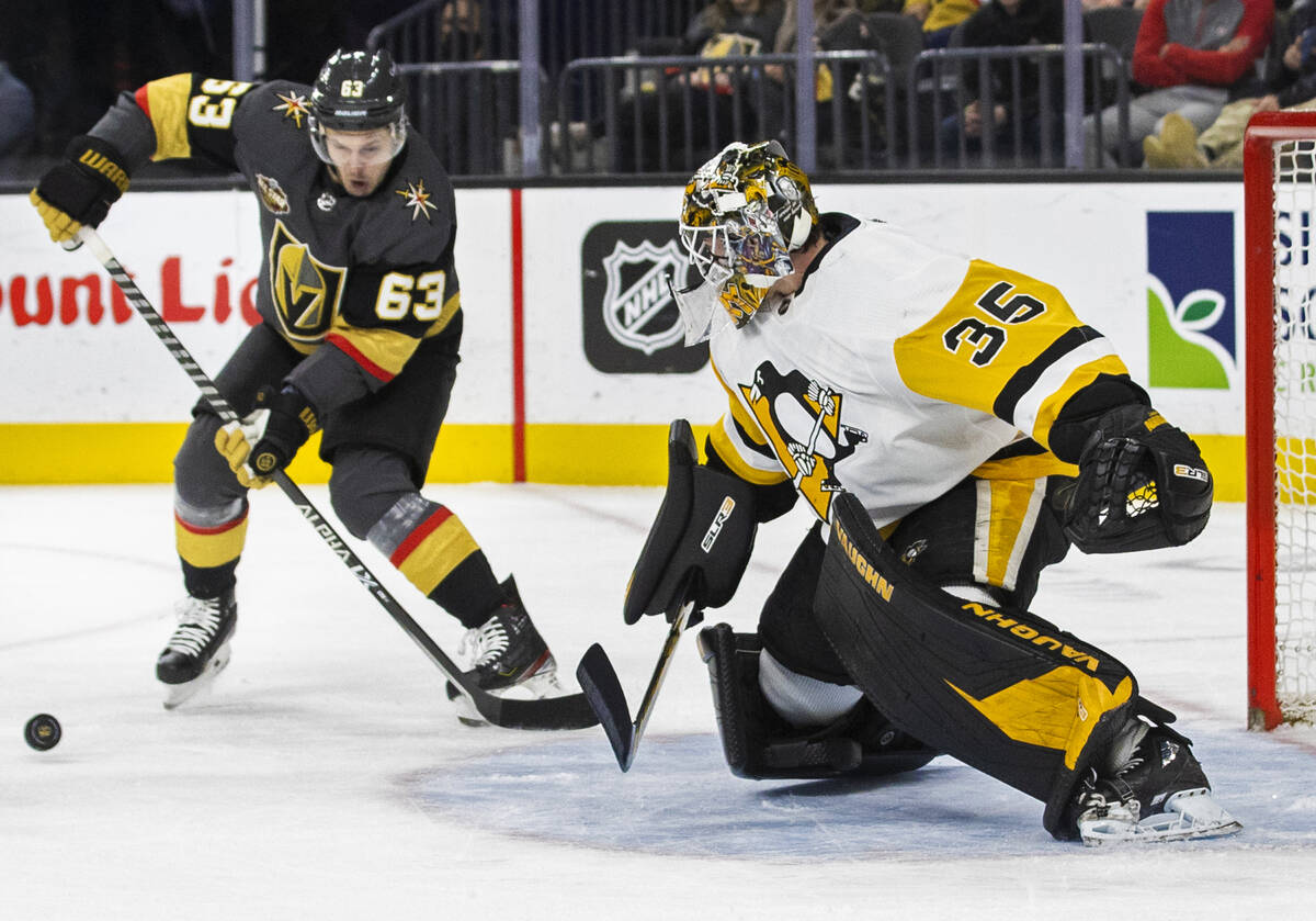 Golden Knights right wing Evgenii Dadonov (63) shoots on Pittsburgh Penguins goaltender Tristan ...