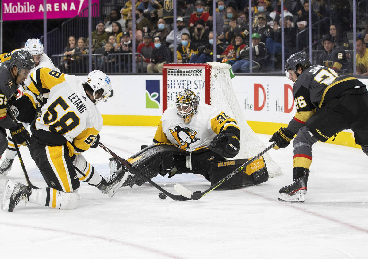 Golden Knights center Mattias Janmark (26) shoots on Pittsburgh Penguins goaltender Tristan Jar ...