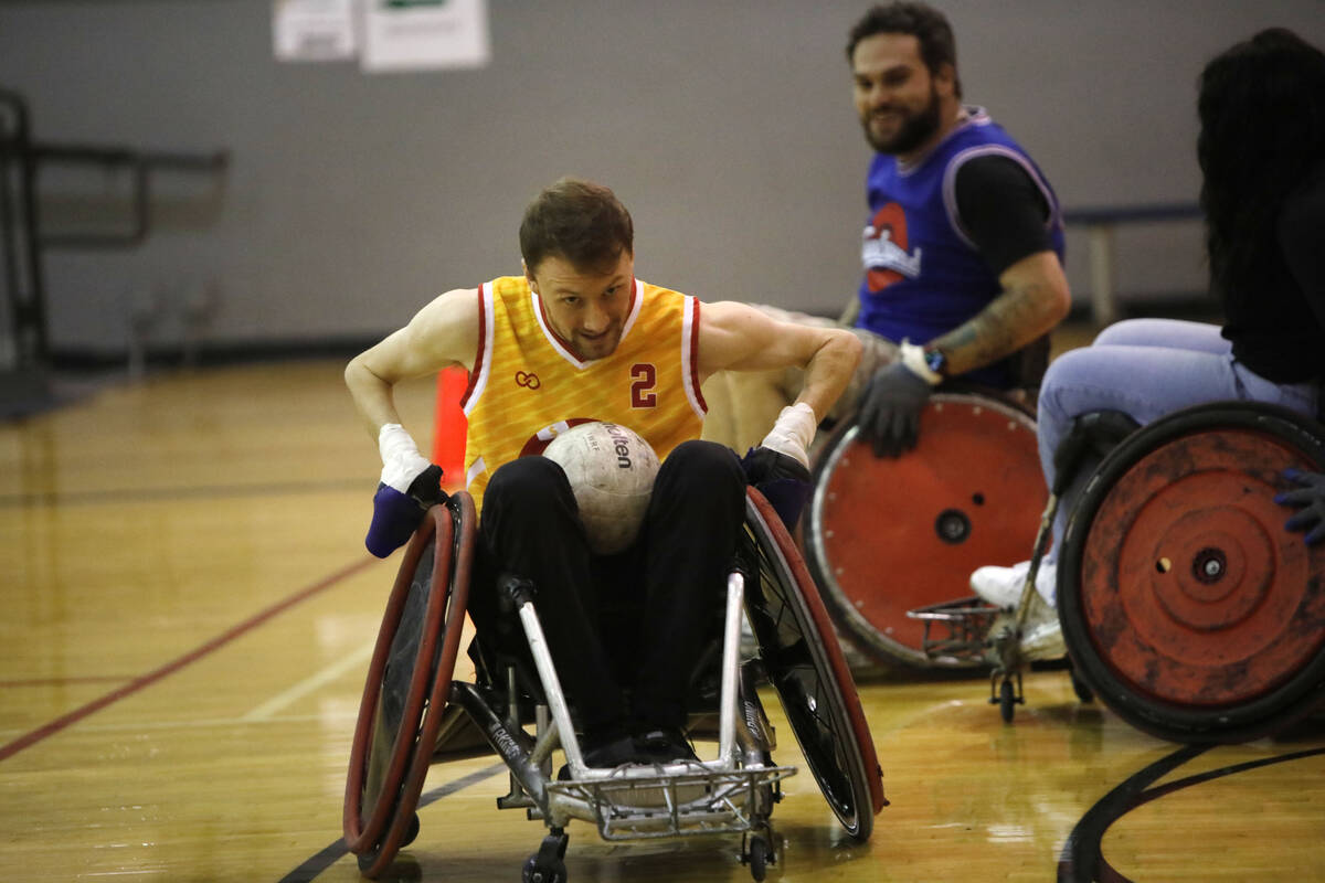 Bradley Boe, High Rollers rugby team founder and player, left, plays wheelchair rugby with Pete ...