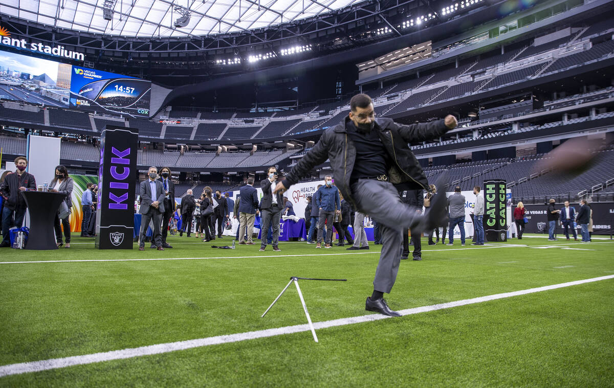 Jesus Valdovinos with Bank of Nevada kicks a football during a run, pass and kick event during ...