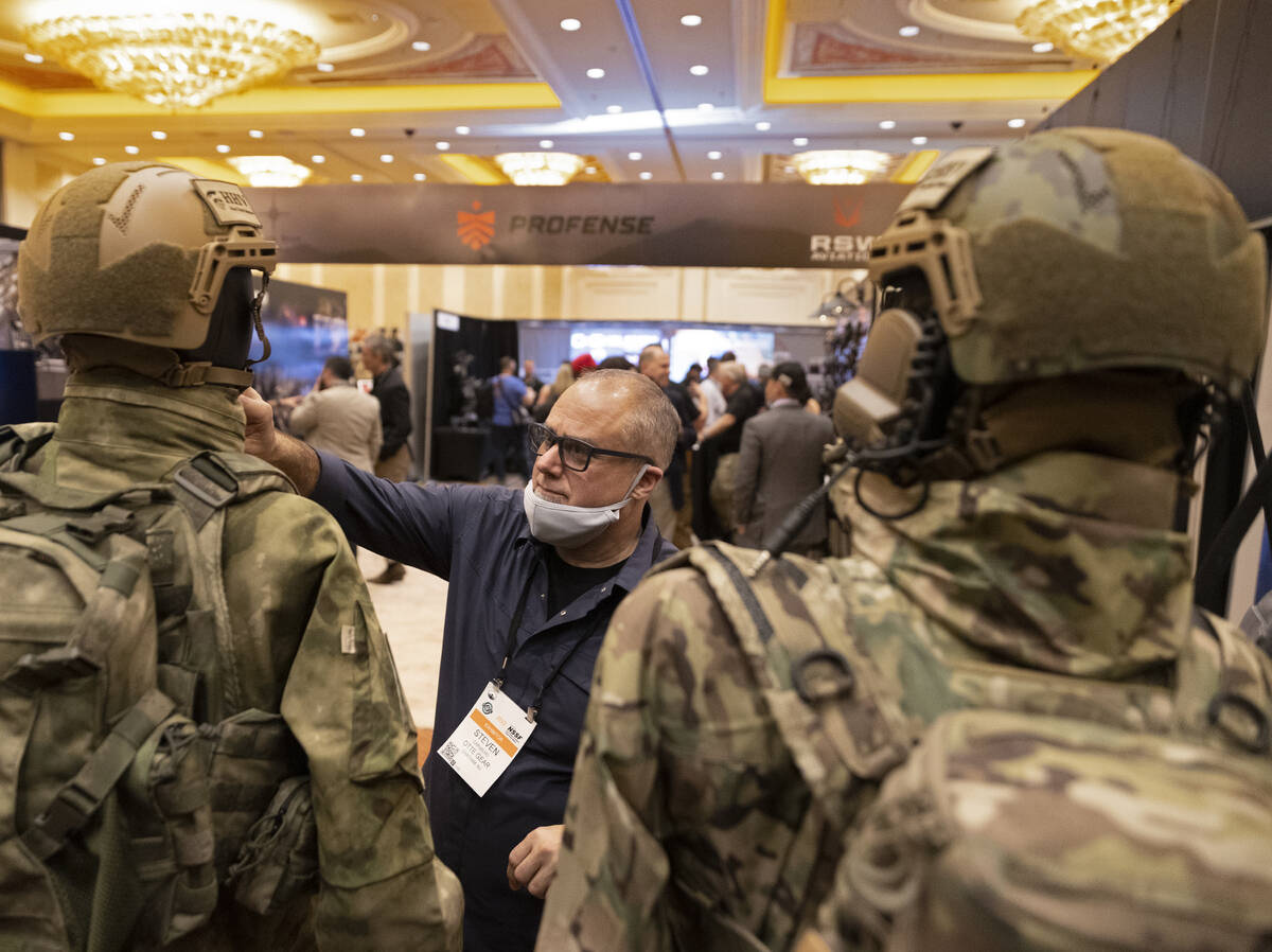 Steven Carvalho, with Otte Gear, adjusts one of his mannequins during the SHOT Show shooting, h ...