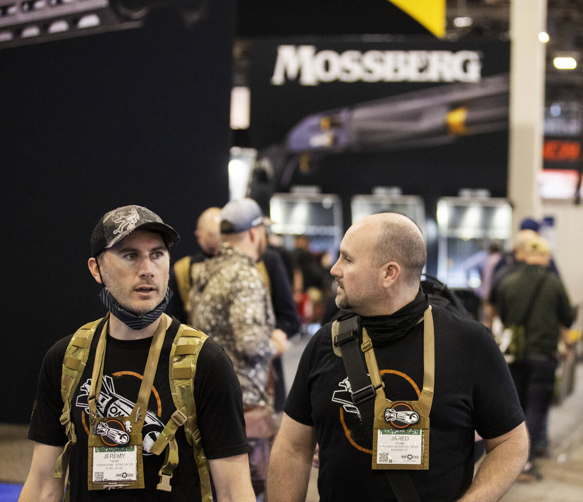 Jeremy, left, and Jared Tremp, with Offensive Marketing Group, walk the convention halls during ...