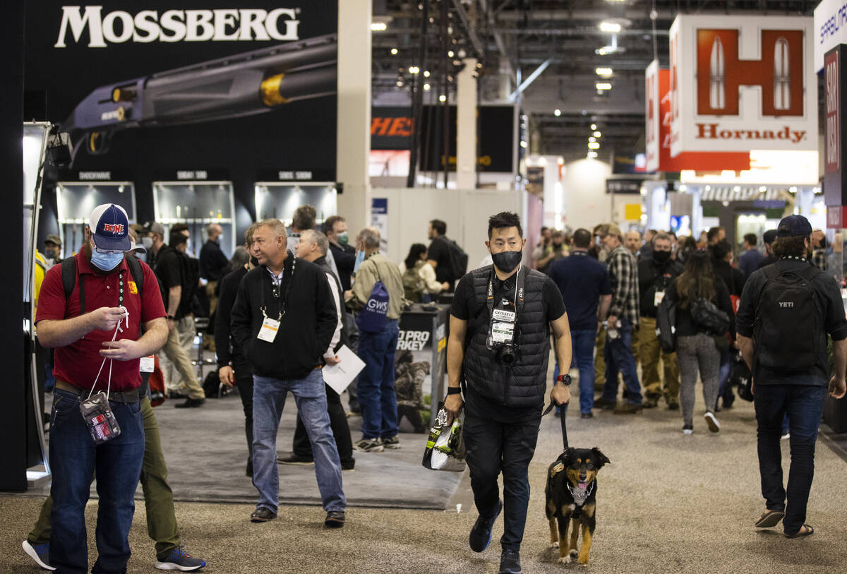 Attendees walk the convention halls during the SHOT Show shooting, hunting and outdoor trade sh ...