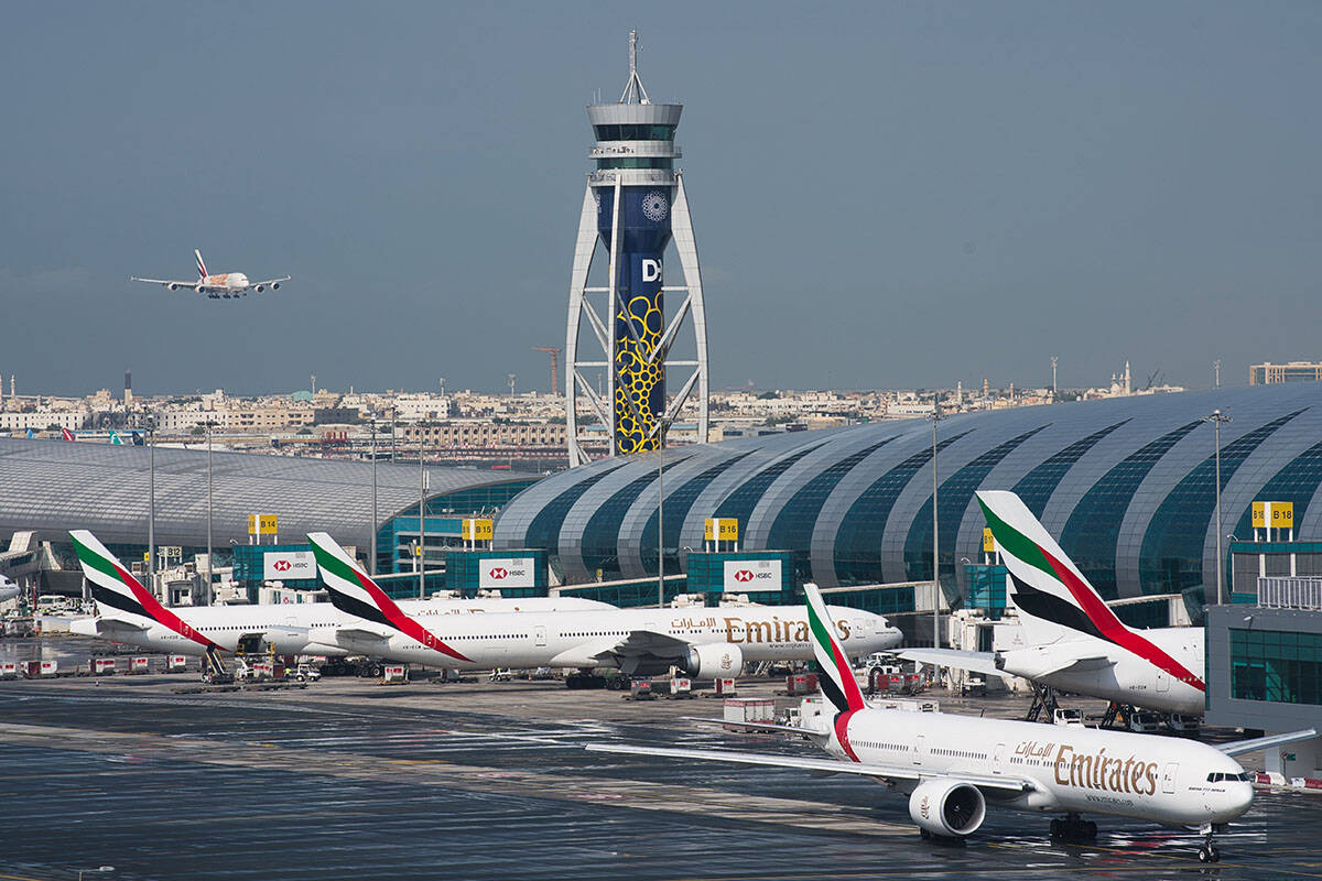 An Emirates jetliner comes in for landing at the Dubai International Airport in Dubai, United A ...
