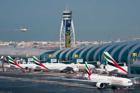 An Emirates jetliner comes in for landing at the Dubai International Airport in Dubai, United A ...