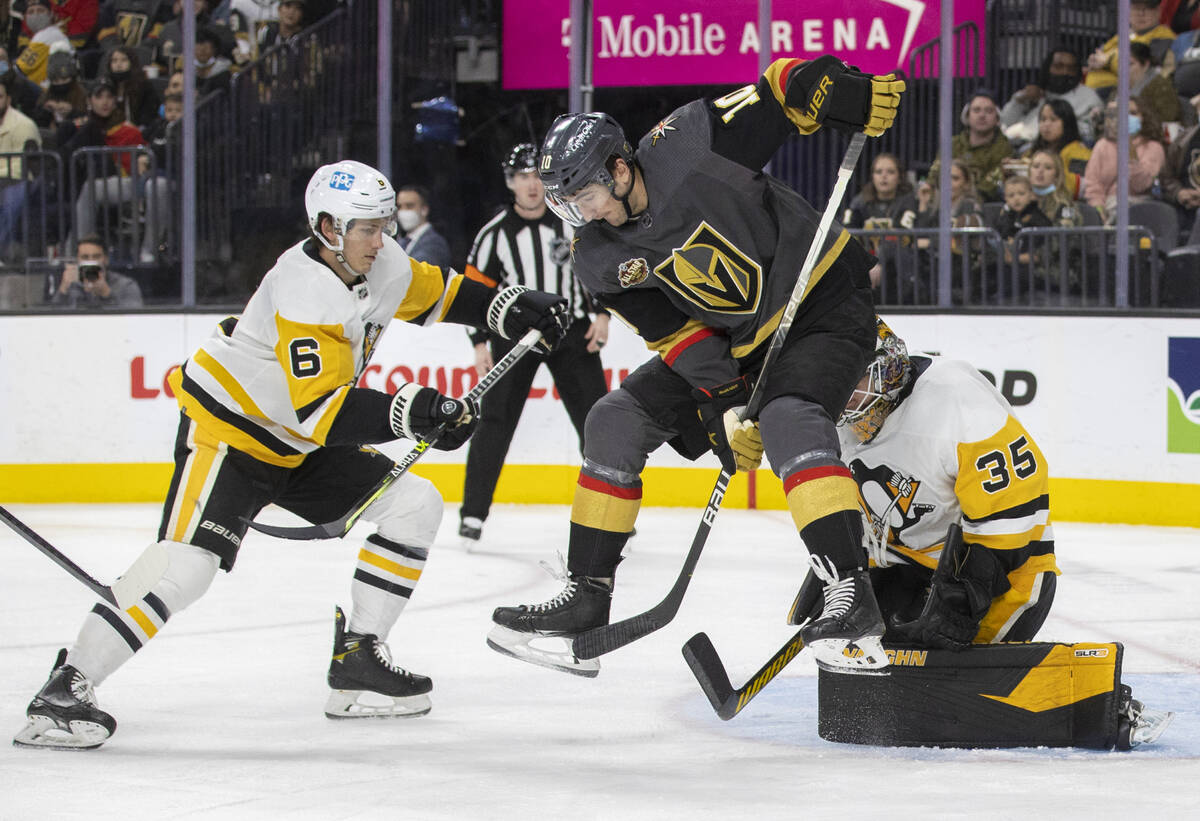 Golden Knights center Nicolas Roy (10) leaps to try and redirect a shot past Pittsburgh Penguin ...