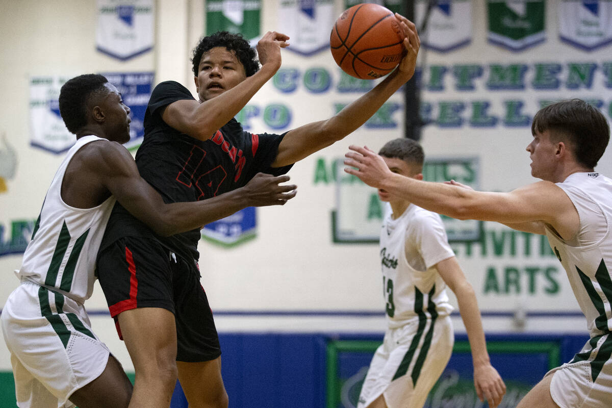 Las Vegas’ Justin White (14) looks to pass while Green Valley’s Kaylan Doby (21) ...