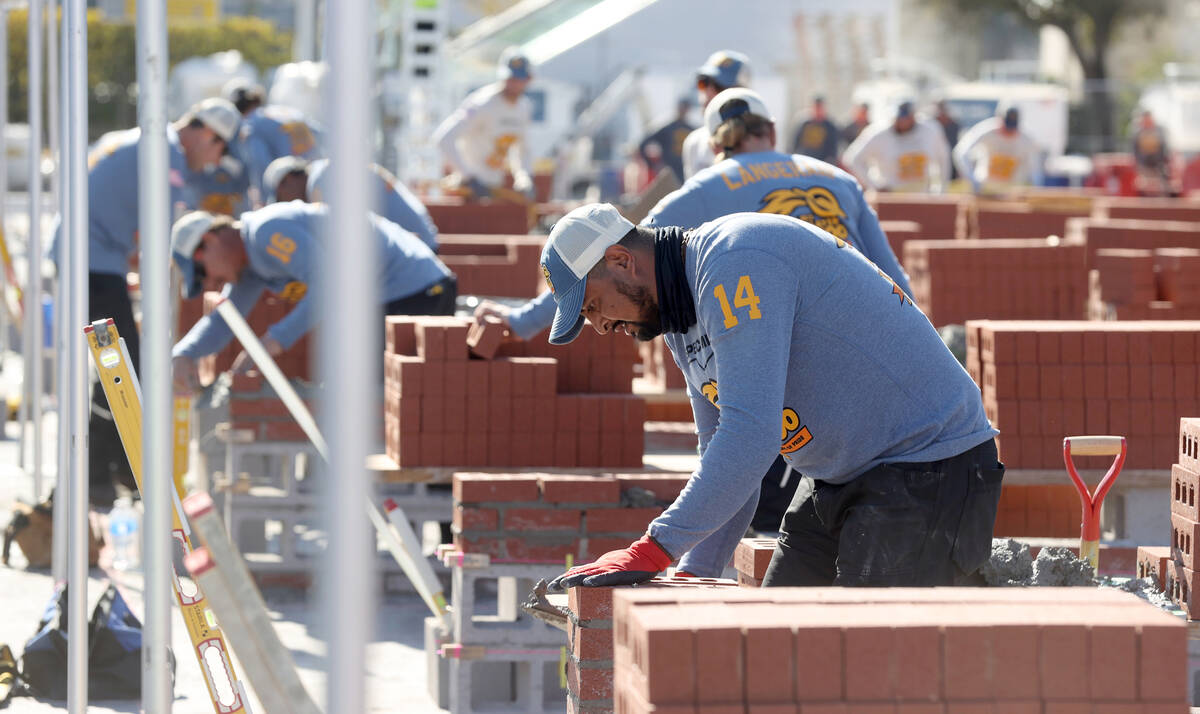 Masons, including Manuel Prado (14) of Brazos Masonry in Waco, Texas, compete in the Bricklayer ...