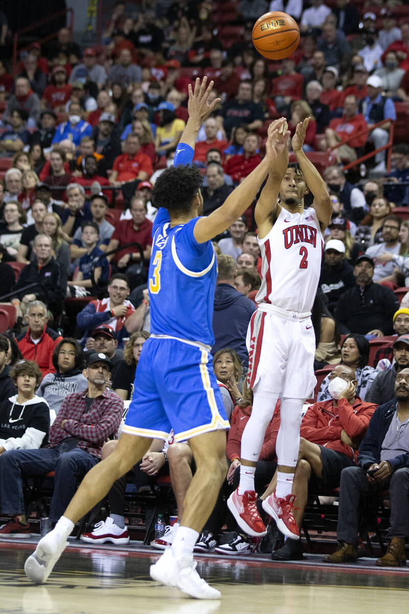 UNLV Rebels guard Justin Webster (2) shoots against UCLA Bruins guard Johnny Juzang (3) during ...