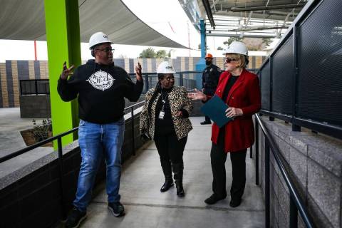 Kathi Thomas, director of community services for the city of Las Vegas, center, leads a tour fo ...