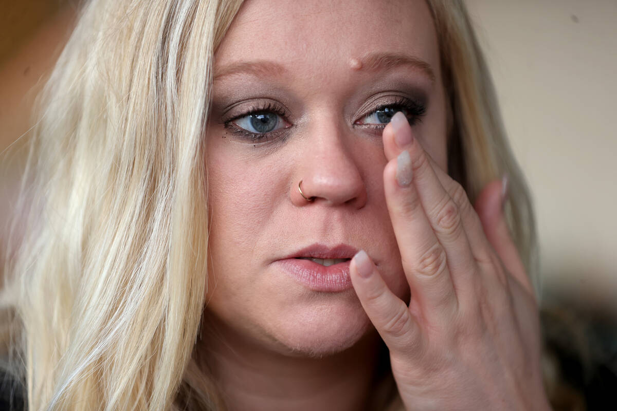 Amanda Brooks wipes away tears as she talks about her boyfriend, Curtis Abraham, was killed in ...