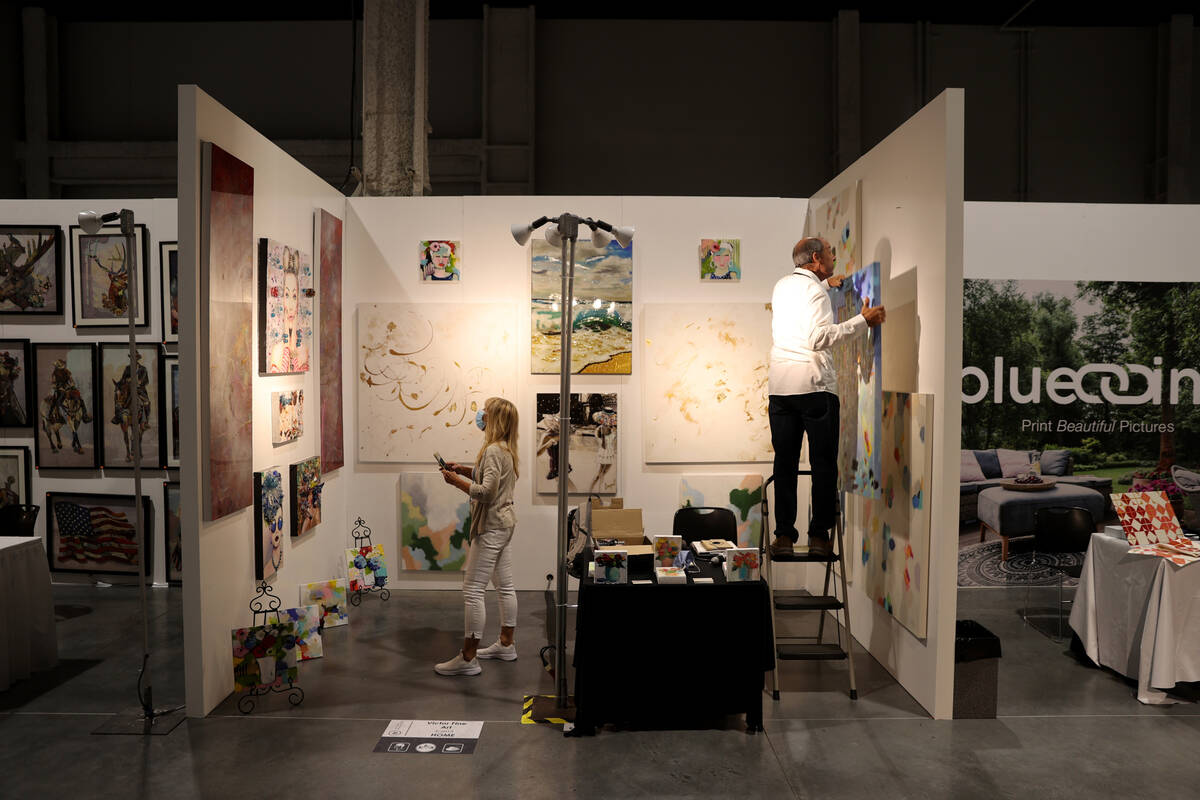 Victor Pizzolato of Victor Fine Art prepares his booth at the Las Vegas Market home furnishings ...