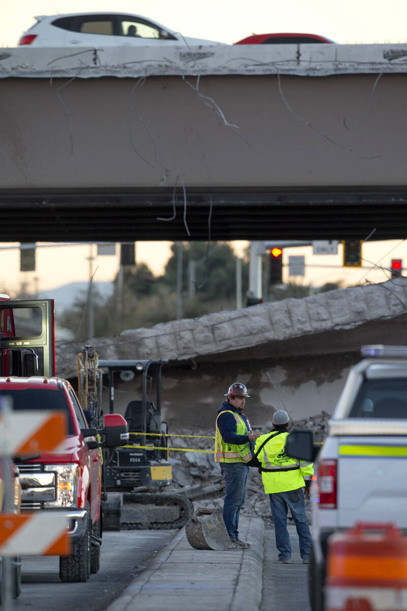 Las Vegas Paving Corp. employees survey the damage after a portion of a  bridge on U.S. 95 over …