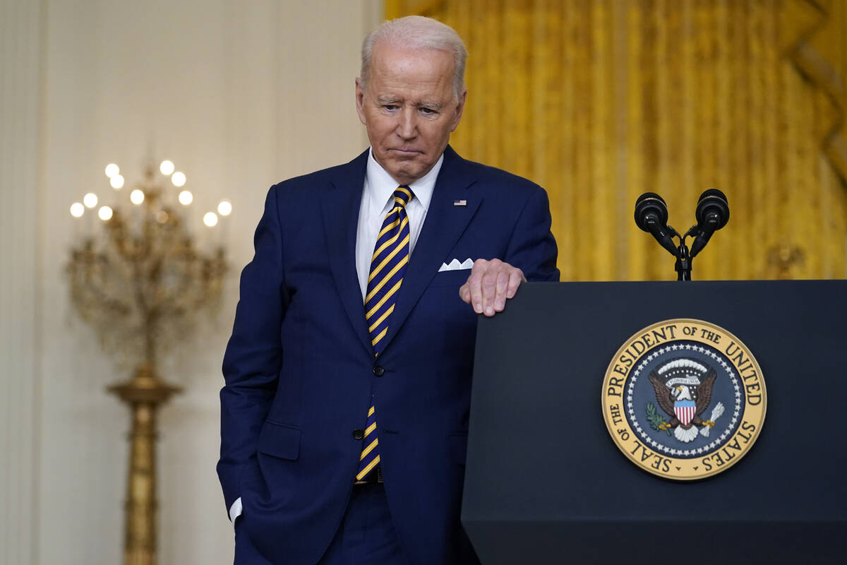 President Joe Biden listens to a question during a news conference in the East Room of the Whit ...