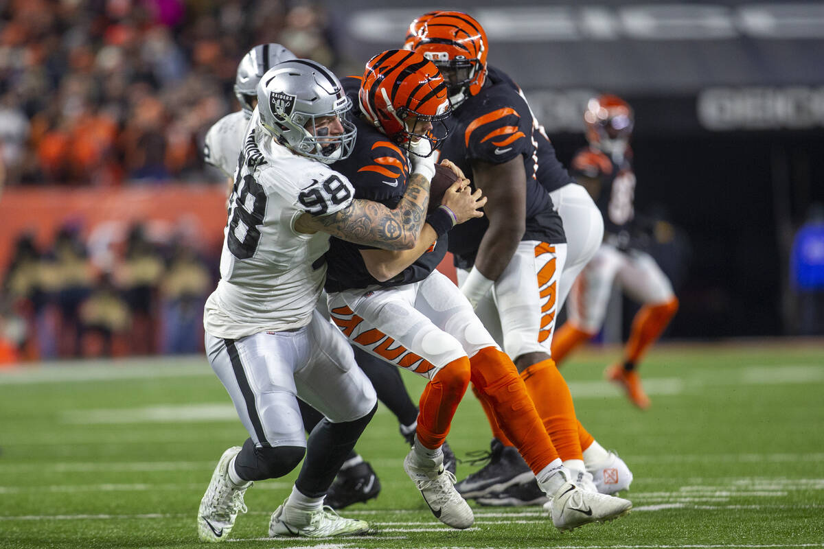 Raiders defensive end Maxx Crosby (98) sacks Cincinnati Bengals quarterback Joe Burrow (9) duri ...