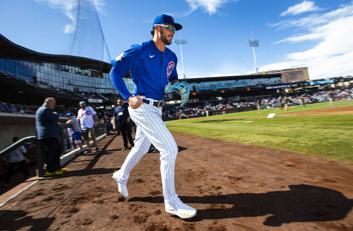 Chicago Cubs' Kris Bryant runs onto the field before the start of a baseball game against the C ...