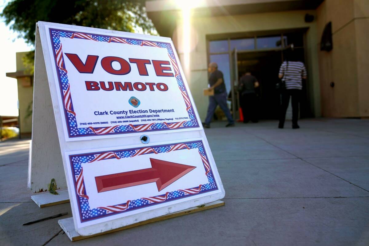 A sign directs people where to vote at a polling place during early voting in Las Vegas in Octo ...