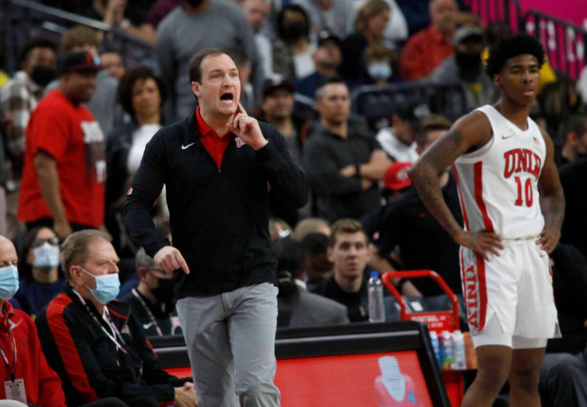 UNLV Rebels head coach Kevin Kruger and UNLV Rebels guard Keshon Gilbert (10) watch the game du ...