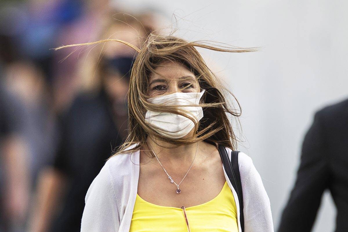 People brave high winds on the Strip on Monday, Oct. 11, 2021, in Las Vegas. Winds are forecast ...
