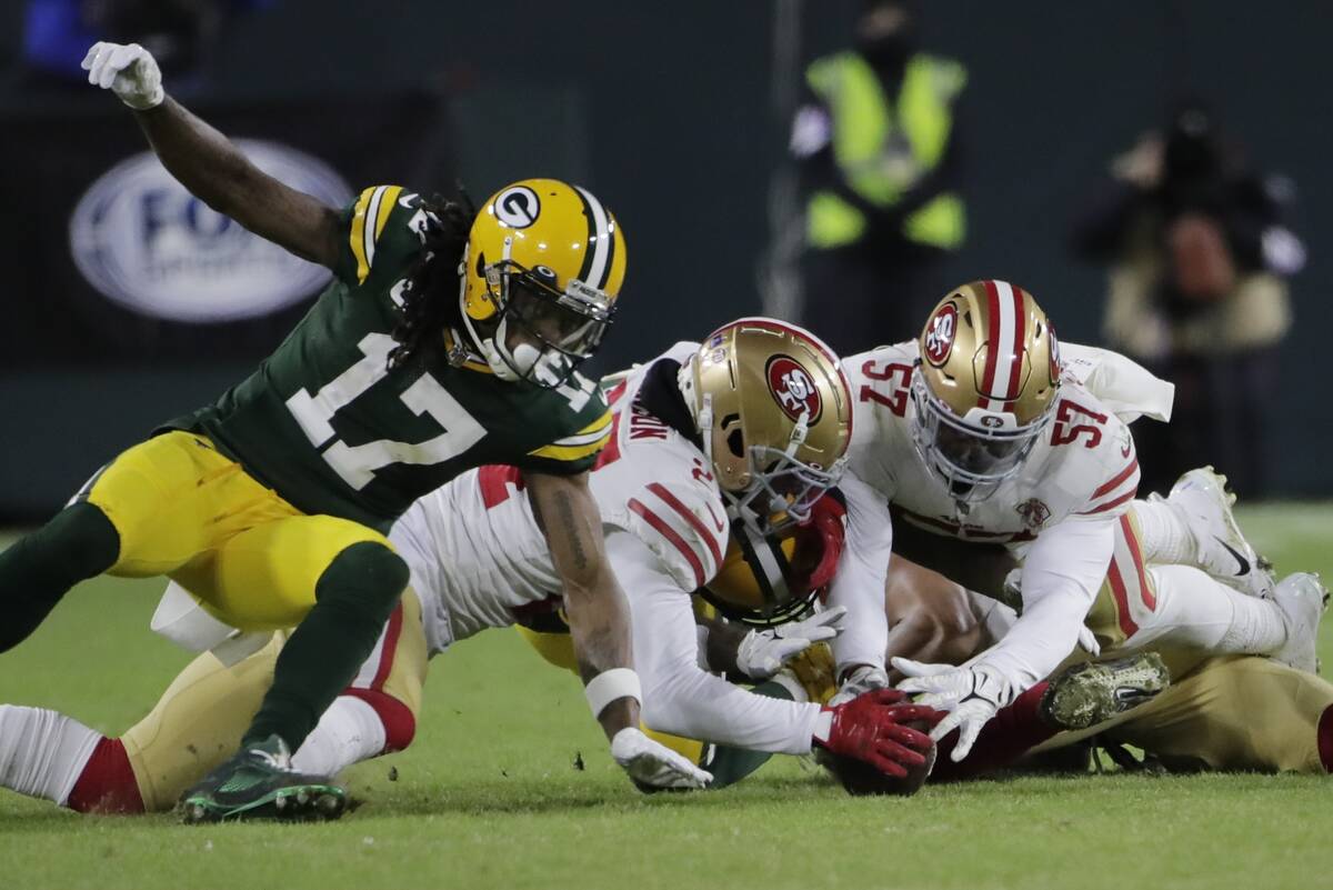 San Francisco 49ers' Dre Greenlaw recovers a fumble during the first half of an NFC divisional ...