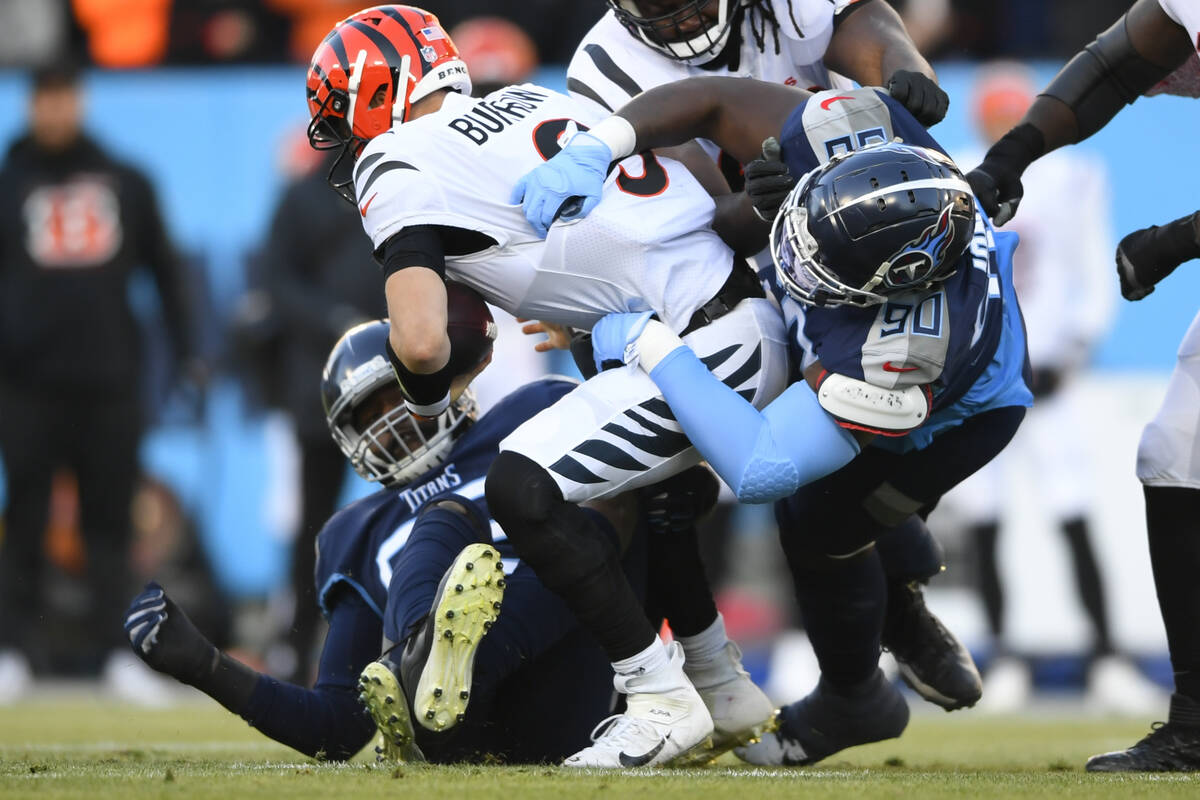 Cincinnati Bengals quarterback Joe Burrow (9) is sacked by Tennessee Titans defensive tackle Na ...