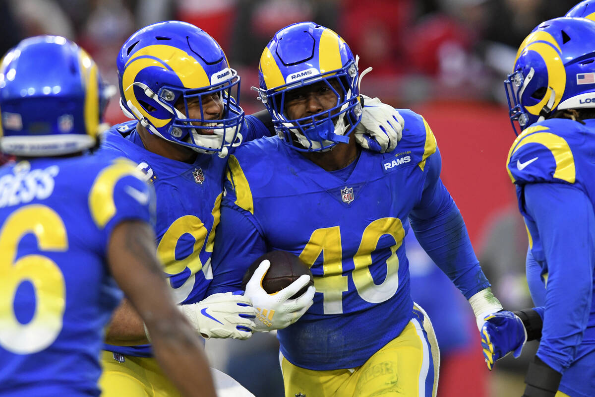Los Angeles Rams outside linebacker Von Miller (40) celebrates with defensive end Aaron Donald ...