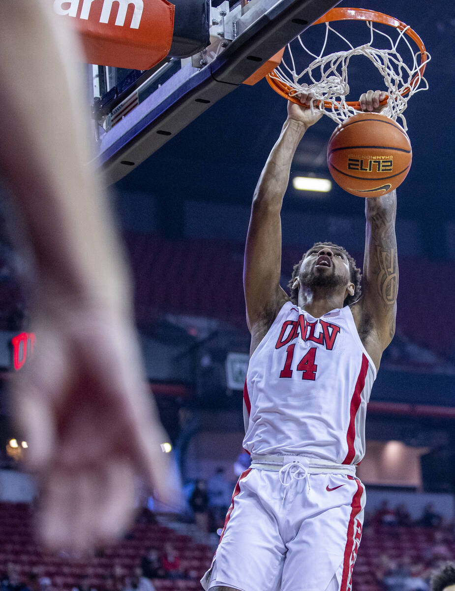 UNLV Rebels forward Royce Hamm Jr. (14) dunks the ball over the San Jose State Spartans defense ...