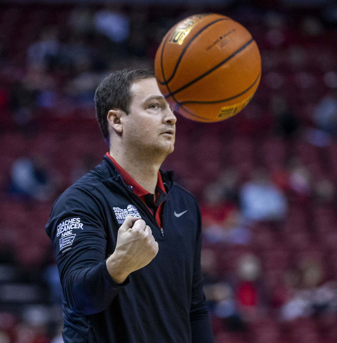 UNLV Rebels head coach Kevin Kruger tosses the ball onto the court versus San Jose State Sparta ...