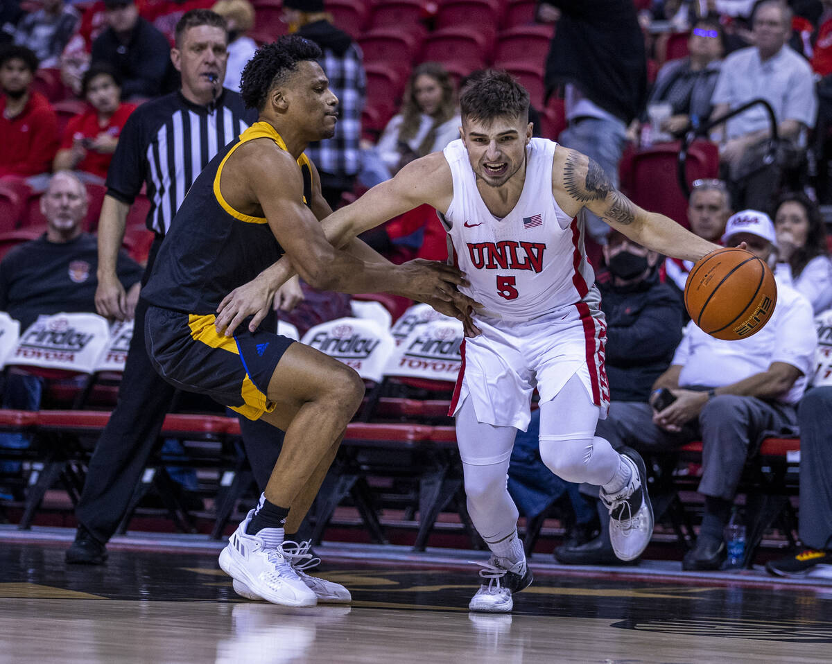 San Jose State Spartans guard Myron Amey Jr. (0) fouls UNLV Rebels guard Jordan McCabe (5) from ...