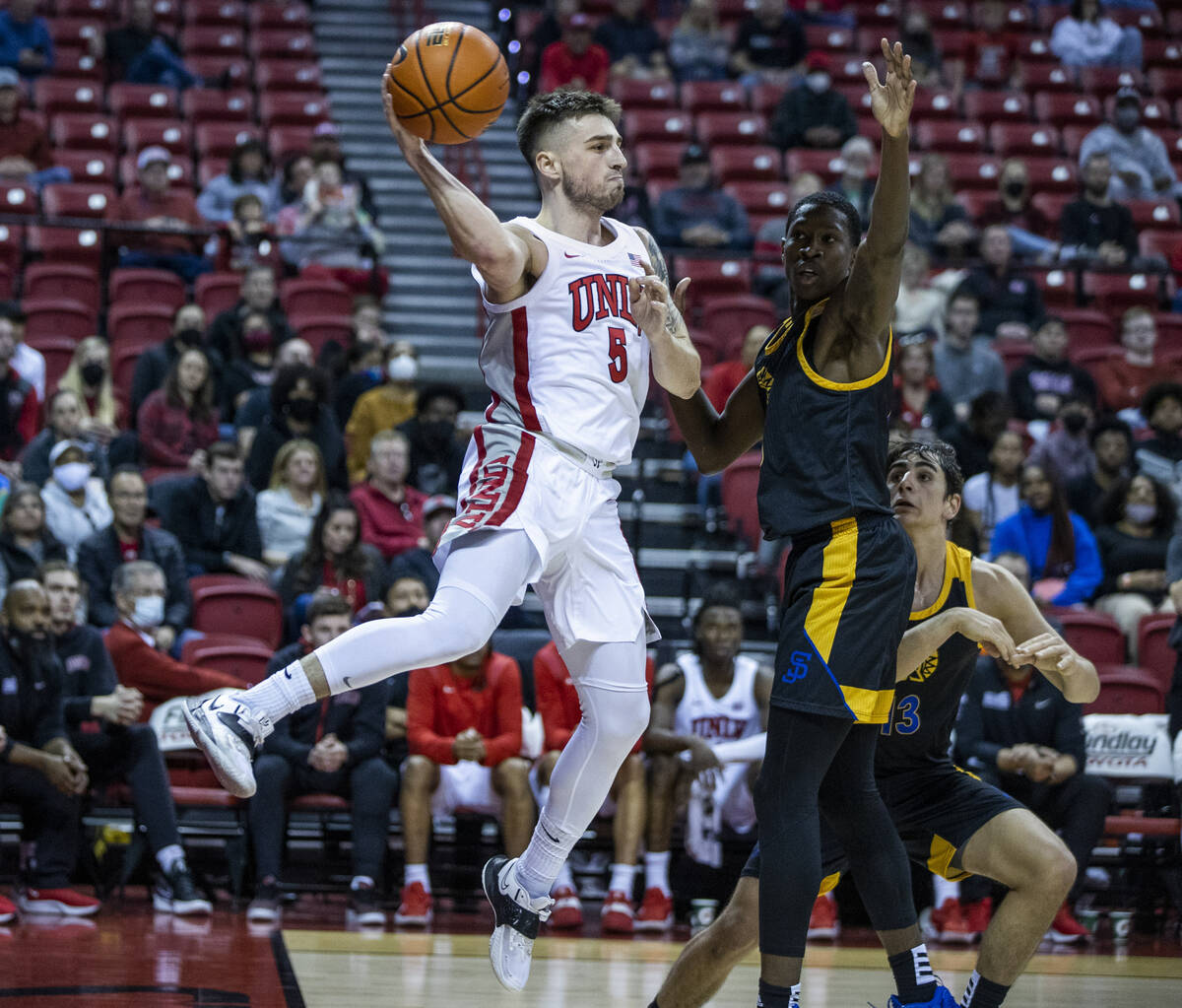 UNLV Rebels guard Jordan McCabe (5) elevates for a pass around San Jose State Spartans guard Om ...