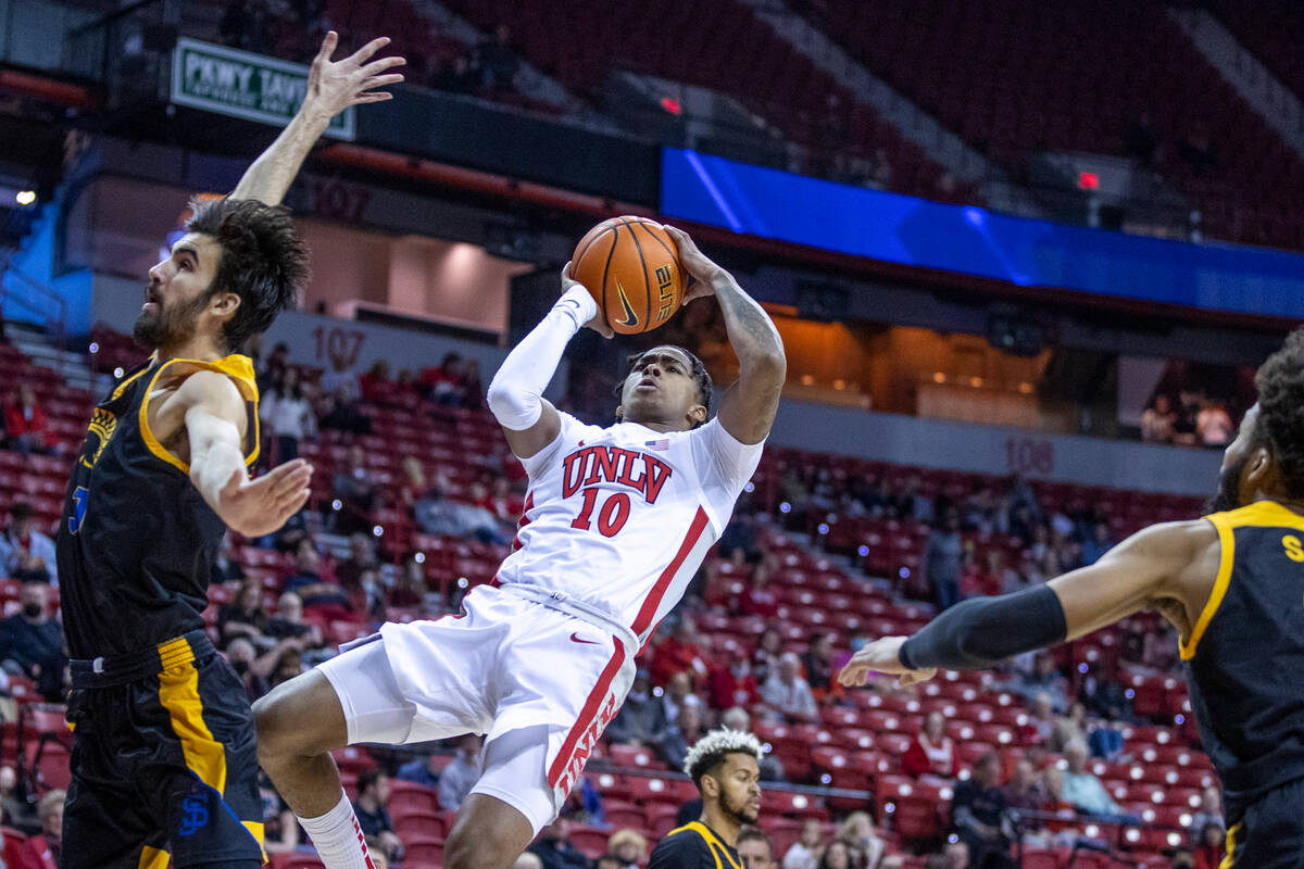 UNLV Rebels guard Keshon Gilbert (10) looks to shoot as San Jose State Spartans forward Tibet G ...