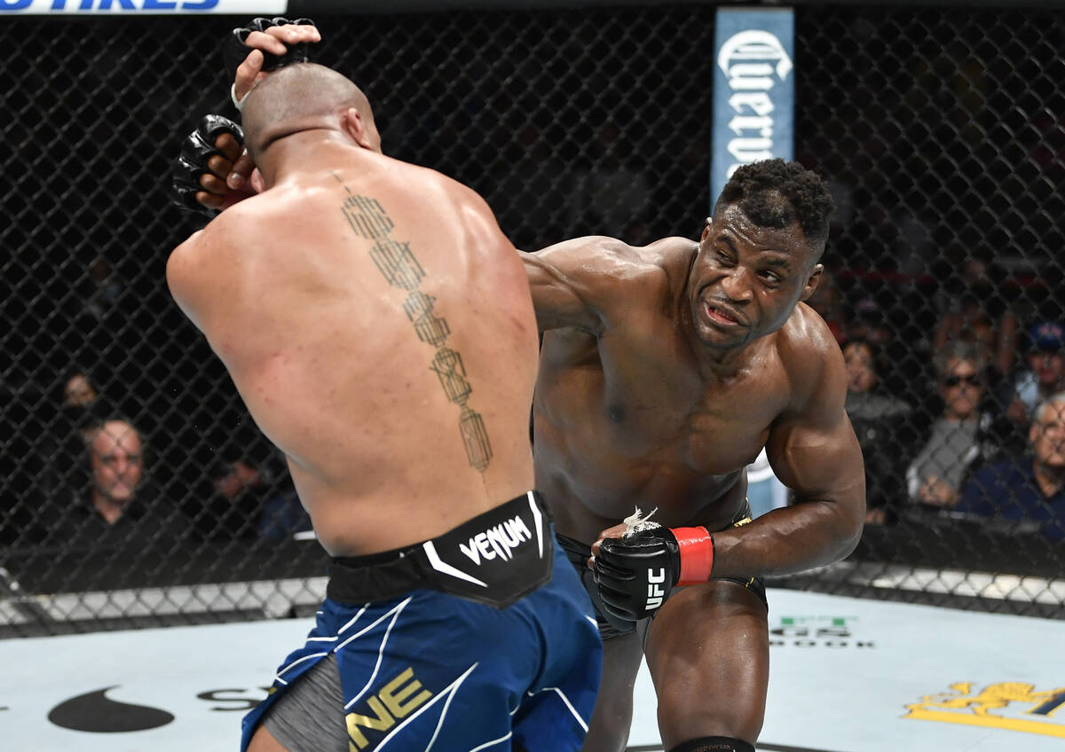 Francis Ngannou, right, of Cameroon punches Ciryl Gane of France in their UFC heavyweight champ ...