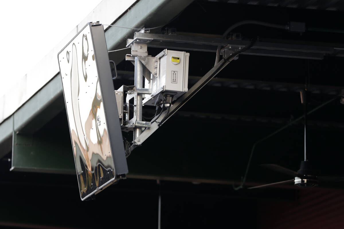 FILE - In this July 10, 2019, file photo, a radar device is seen on the roof behind home plate ...