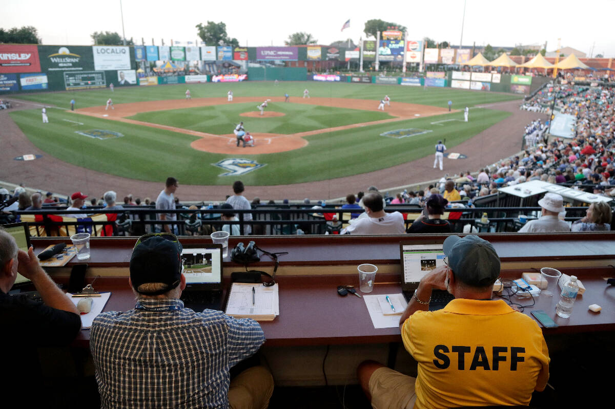 FILE - In this July 10, 2019, file photo, Ron Besaw, right, operates a laptop computer as home ...